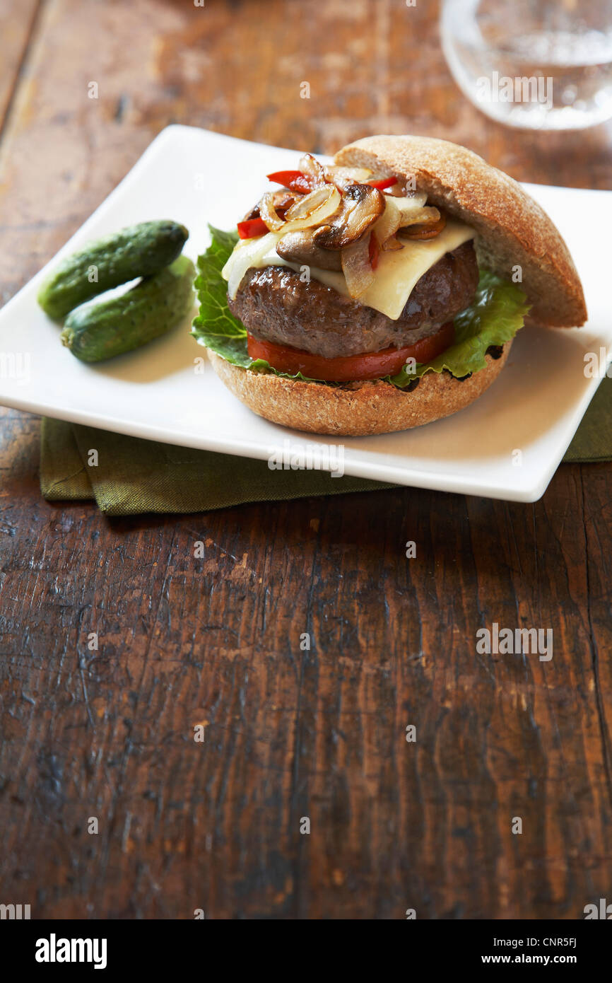 Burger With Mushrooms, Cheese, Peppers and Onions on Whole Wheat Bun