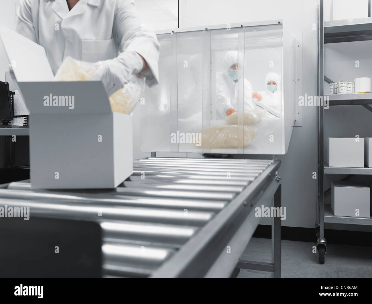 Scientist working on assembly line Stock Photo