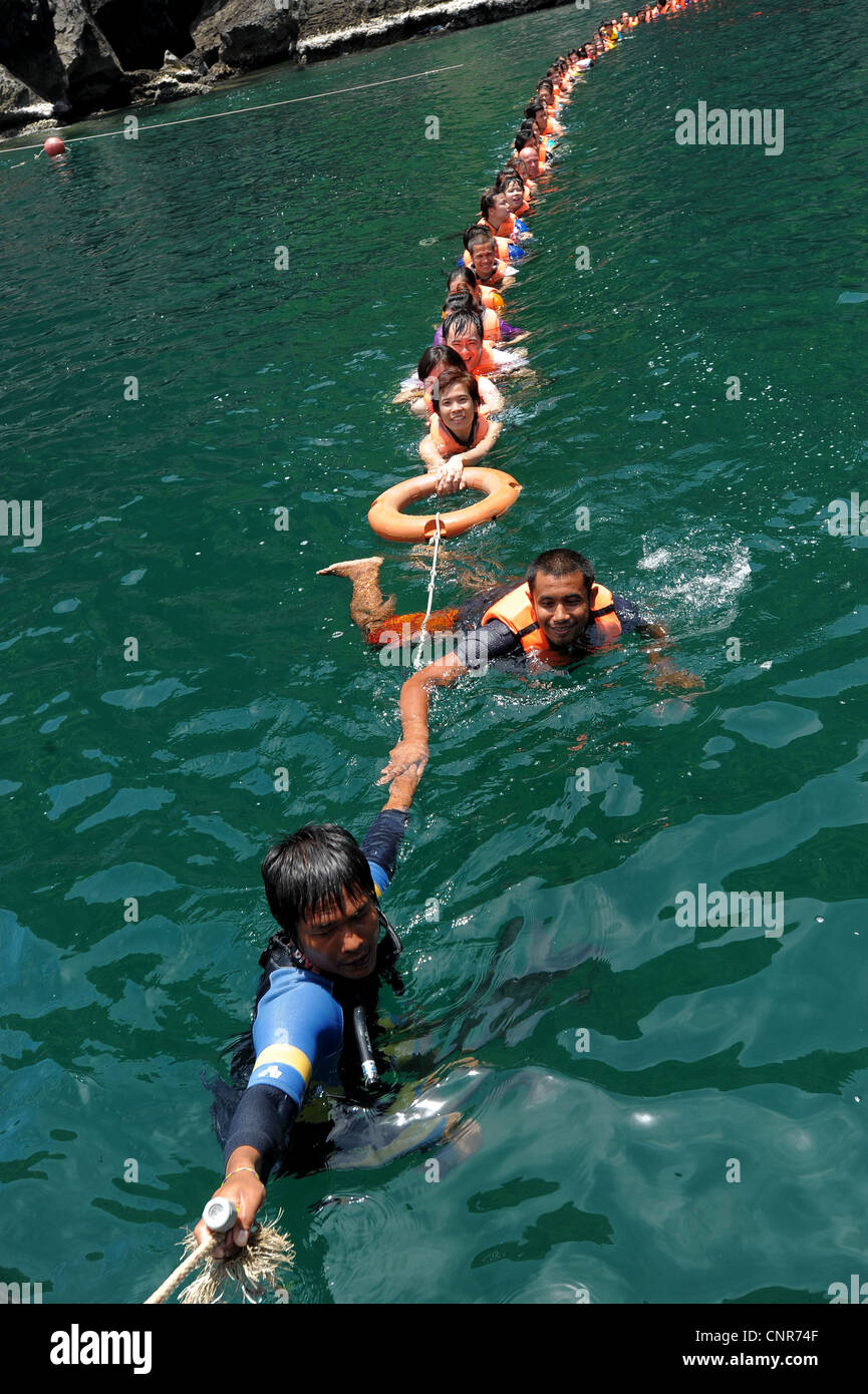 chain of swimmers Swimming out of Morakot cave , the island of koh mook ...