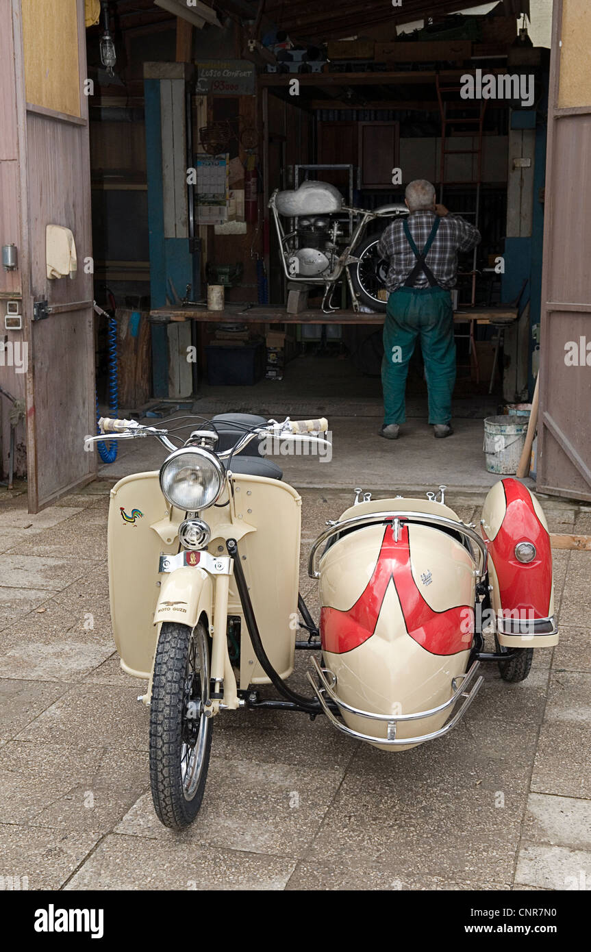 restored vintage Moto Guzzi outside a restoration workshop in Italy Stock Photo