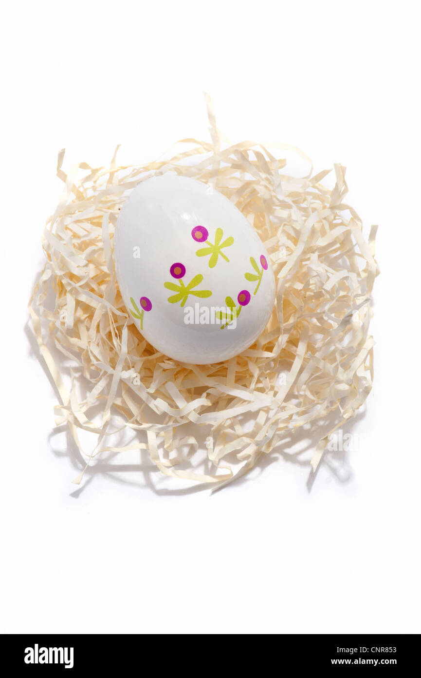 A decorated Easter egg on a paper straw nest Stock Photo - Alamy