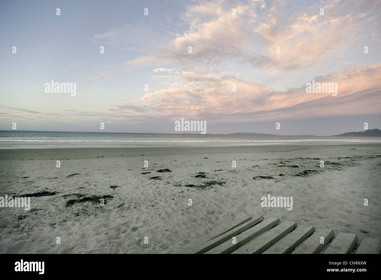 Empty beach under cloudy sky Stock Photo - Alamy