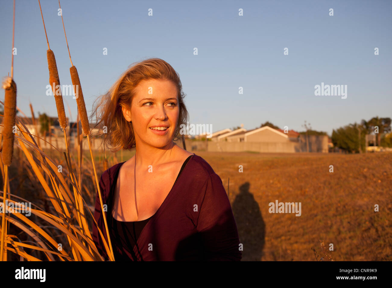 Smiling woman standing in wheat field Stock Photo - Alamy
