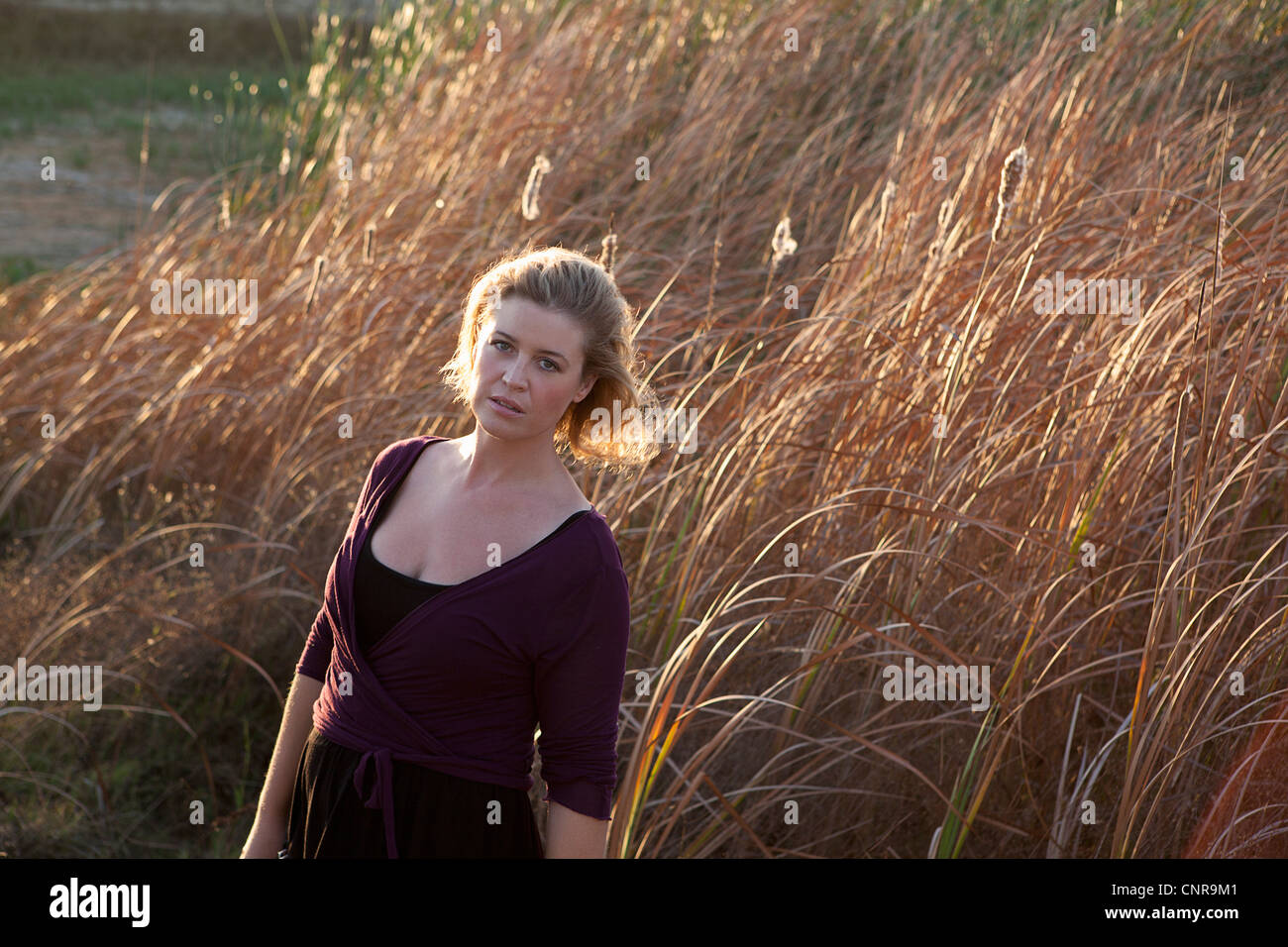Woman standing in wheat field Stock Photo - Alamy
