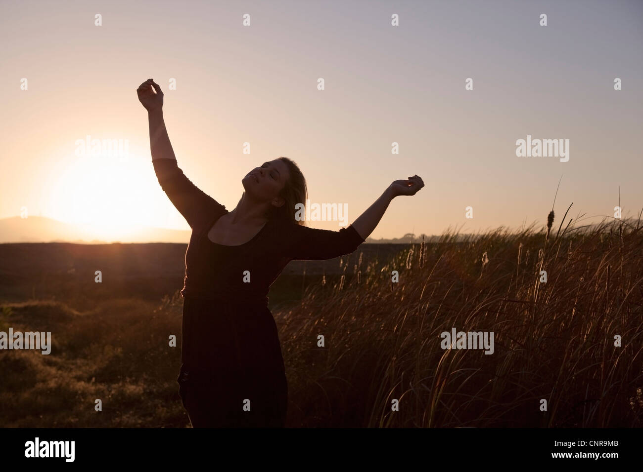 Woman standing in wheat field Stock Photo - Alamy