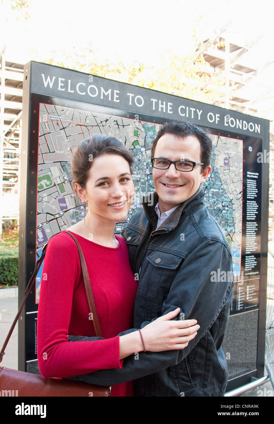 Couple standing by map of London Stock Photo