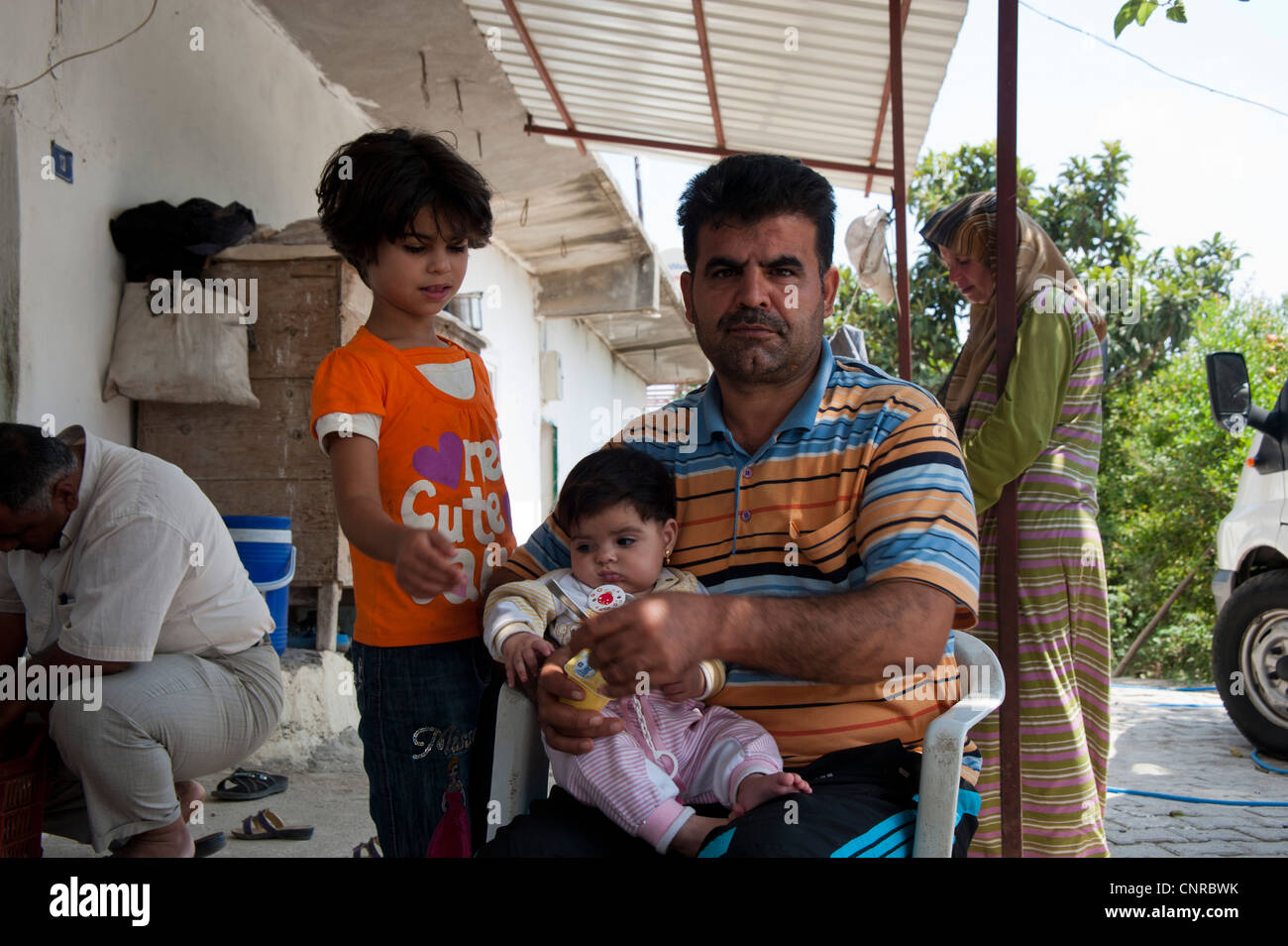 A refugee with his family., A refugee with his family. Stock Photo