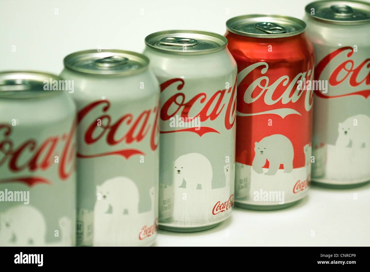 Odd One Out Four White Polar Bear Coke Cans With One Red Coke Can On White Background Stock Photo Alamy