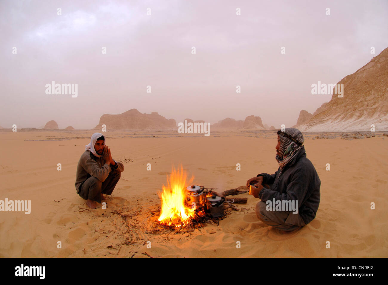 two Beduines at a camp fire in the desert, Egypt, White Desert National  Park Stock Photo - Alamy