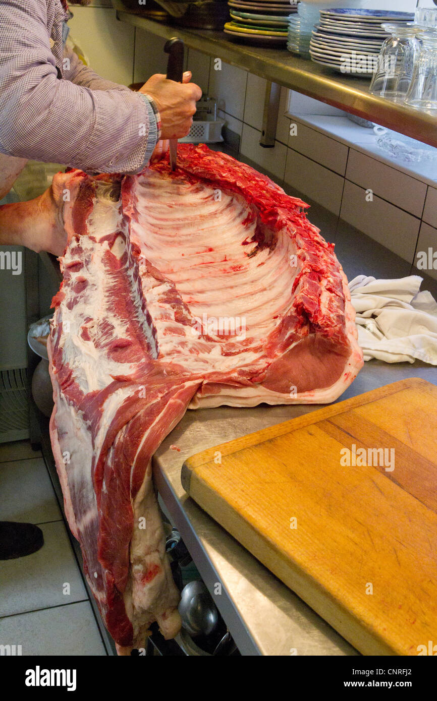 Butcher cutting pork Stock Photo