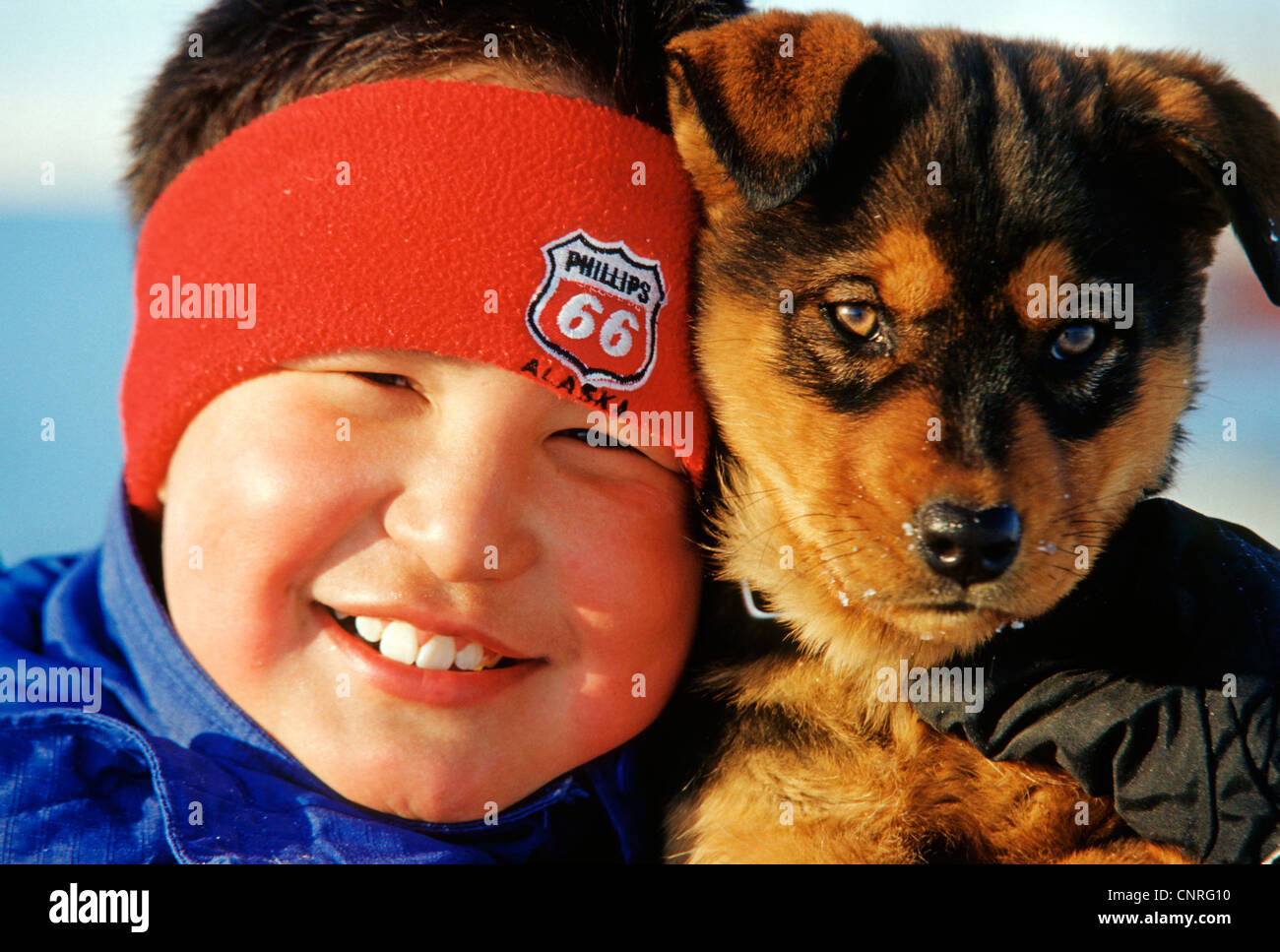 Inuit boy with dog, USA, Alaska Stock Photo