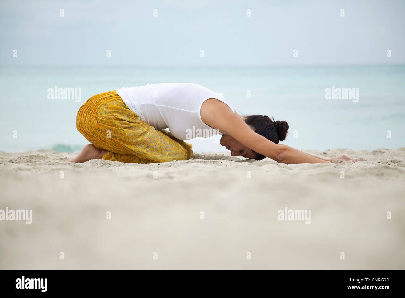 Beautiful Asian Young Woman Practices Yoga Asana Eka Pada Bakasana - One  Leg Crane Pose Asana Yoga Pose. Beautiful Portrait Of Yoga. A Woman  Practices Yoga Alone In The Beach. Side View.