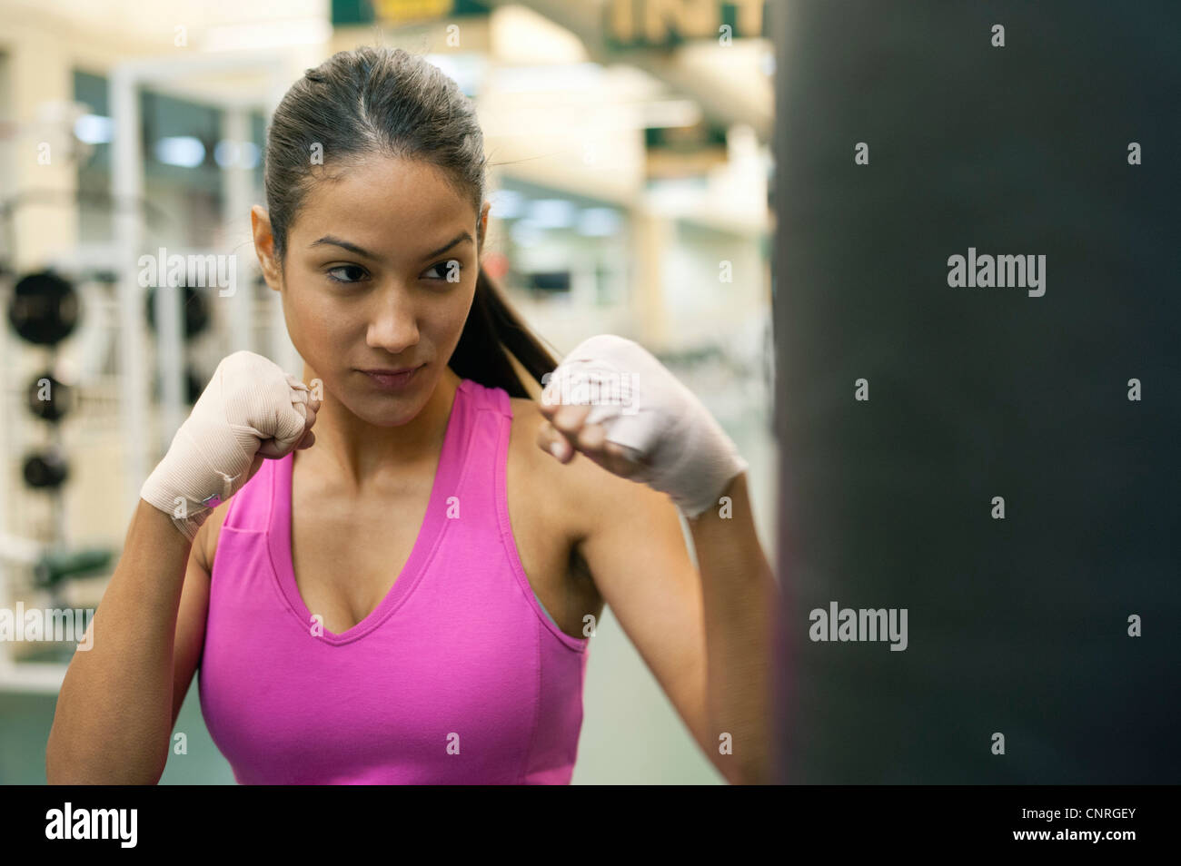 Young woman punching heavy bag Stock Photo Alamy