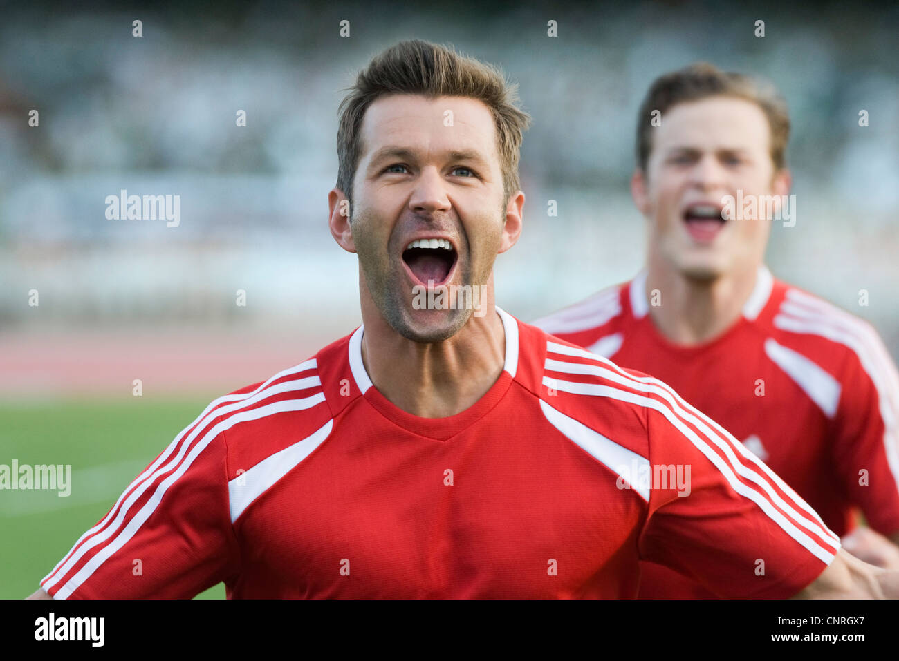 Soccer players cheering Stock Photo