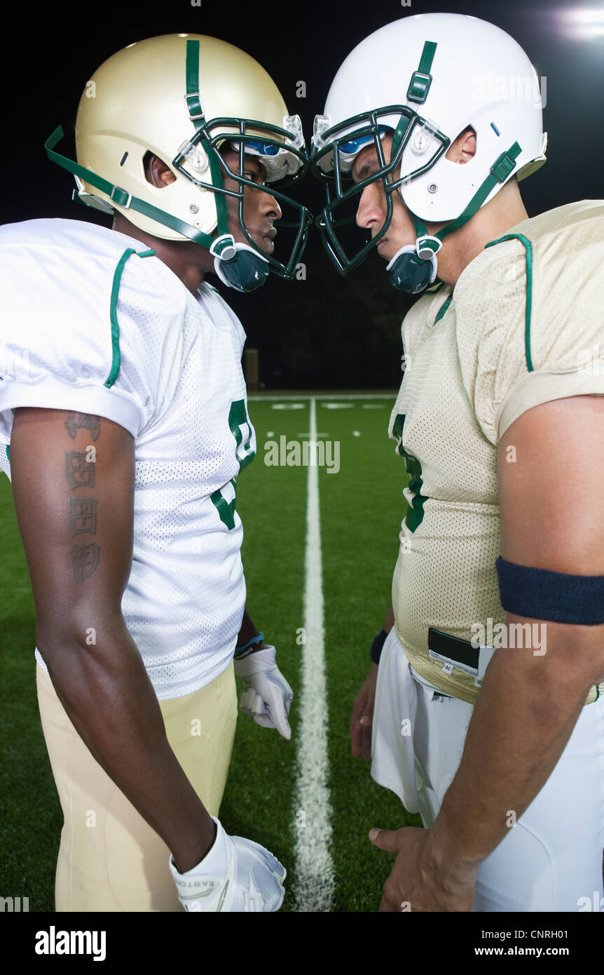 Opposing football players facing off Stock Photo - Alamy