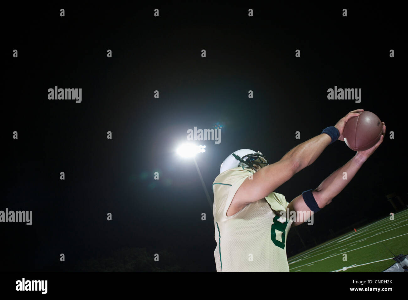 Football player catching football Stock Photo Alamy