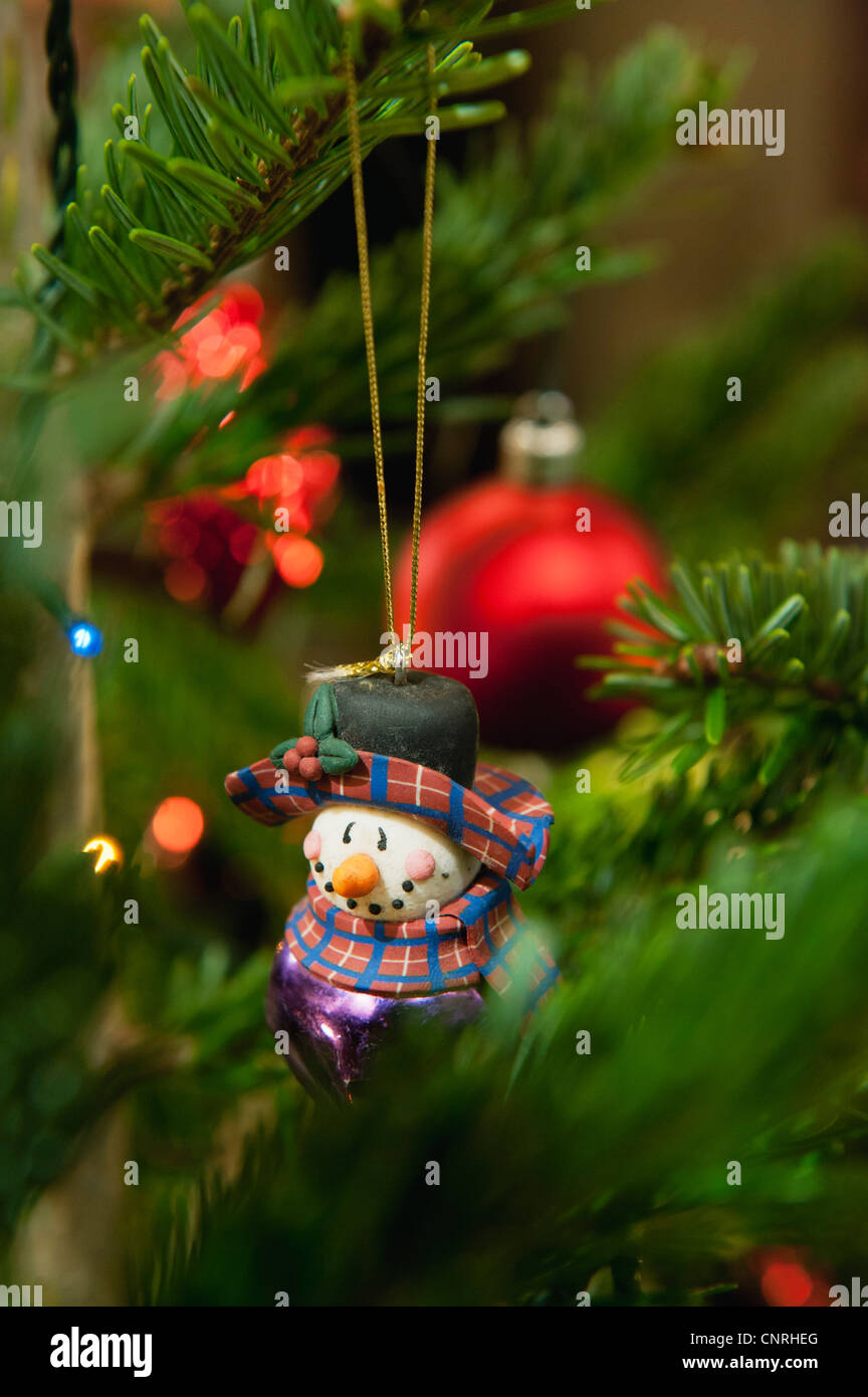 Snowman ornament hanging on Christmas tree Stock Photo