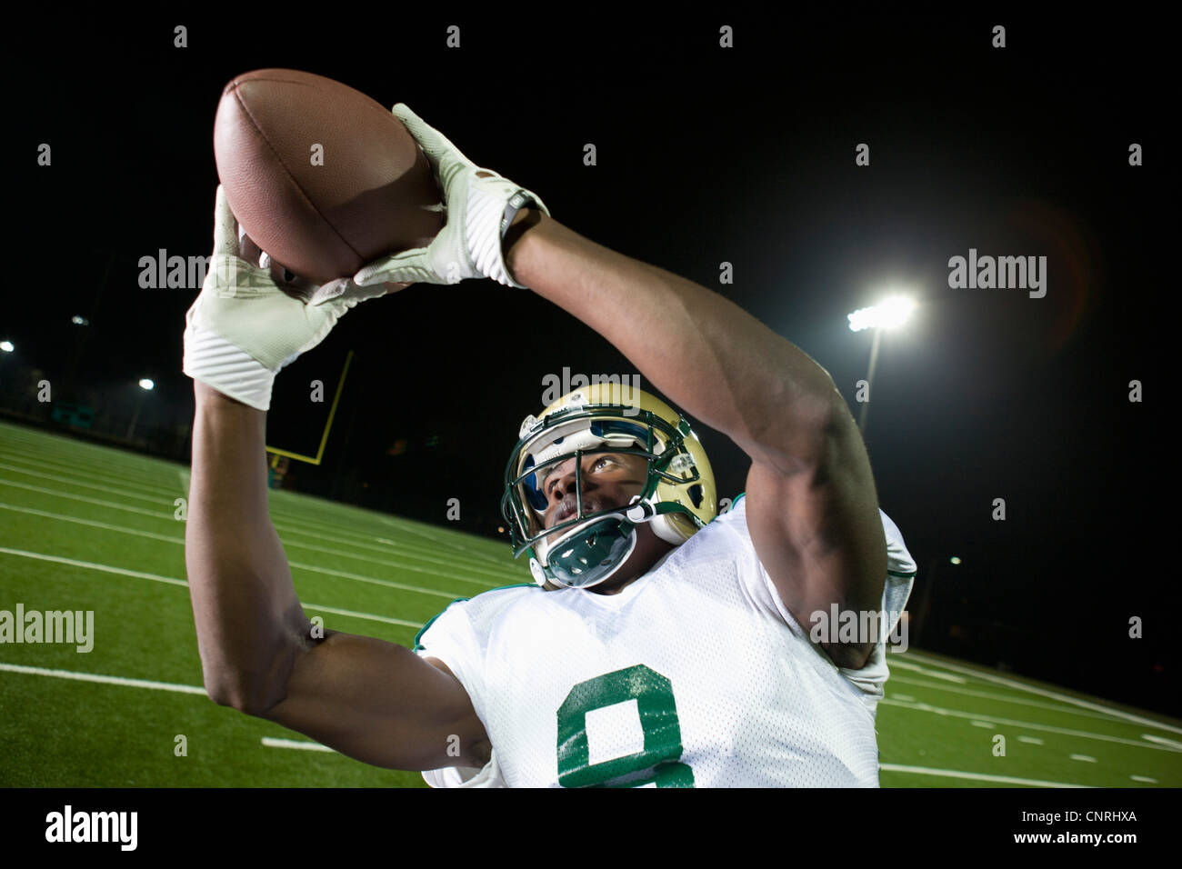 Football player catching ball Stock Photo Alamy