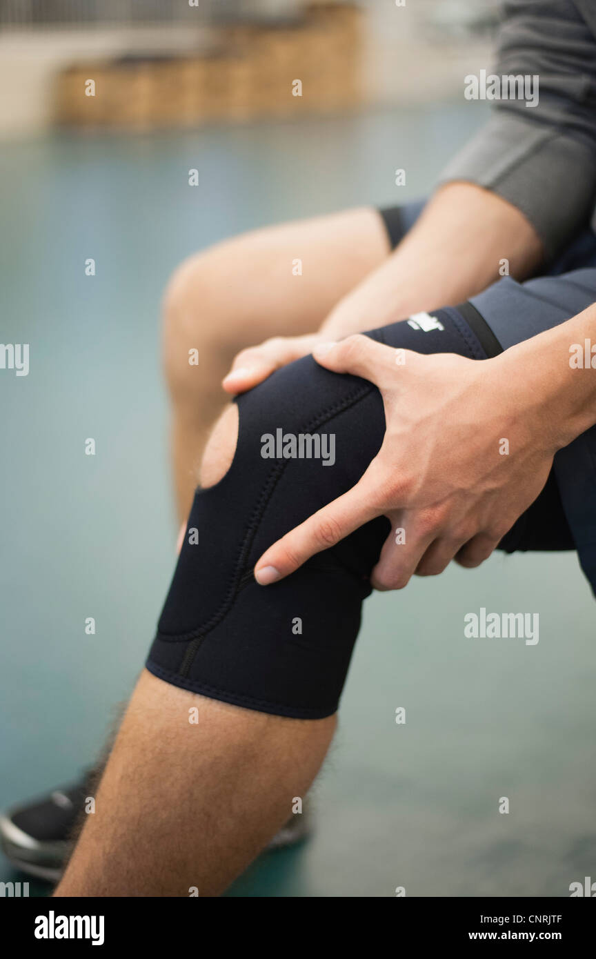 Man wearing knee brace, cropped Stock Photo Alamy