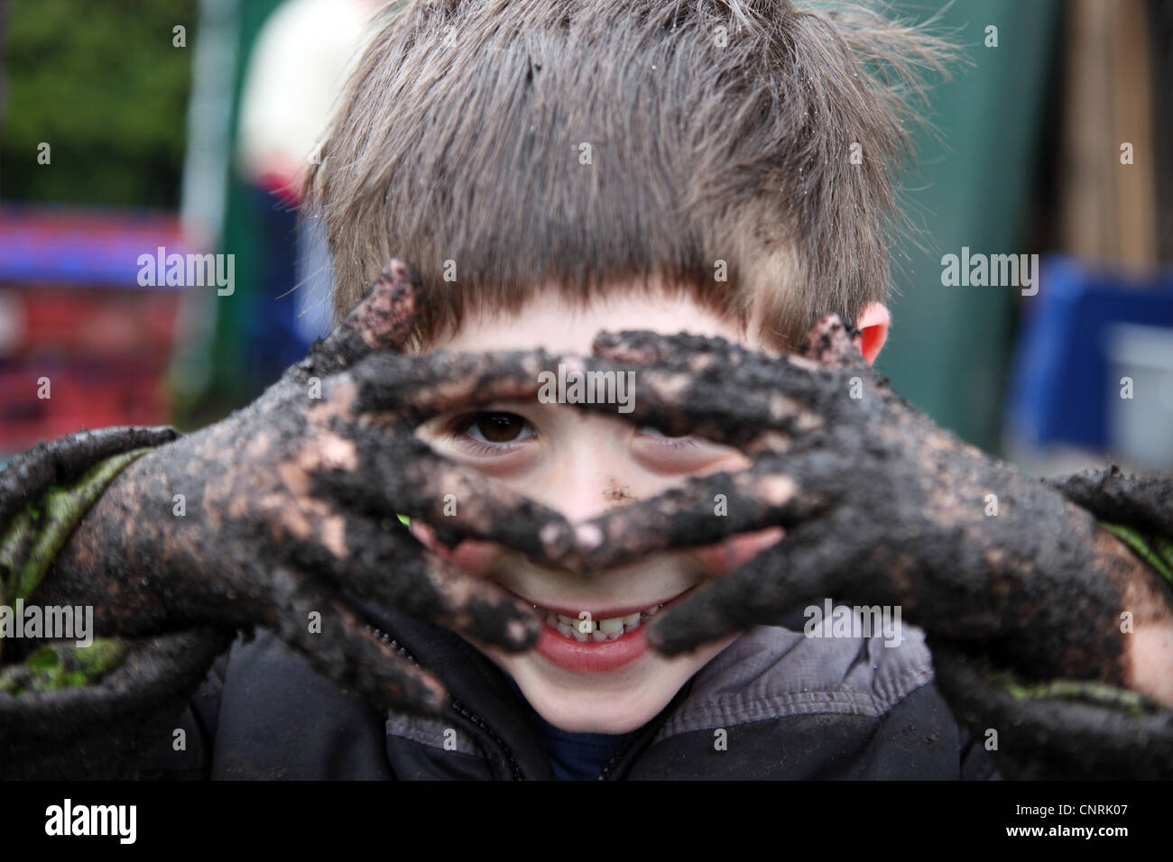 muddy child at the GROW Community Garden, Waterworks, Belfast Stock Photo