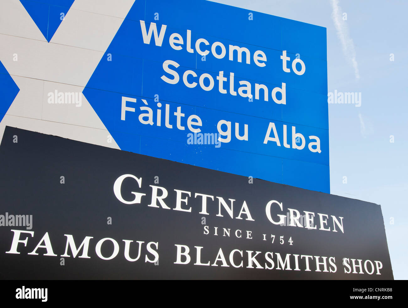 A welcome to Scotland sign and the Blacksmiths shop at Gretna Green, Dumfries and Galloway, Scotland, UK. Stock Photo