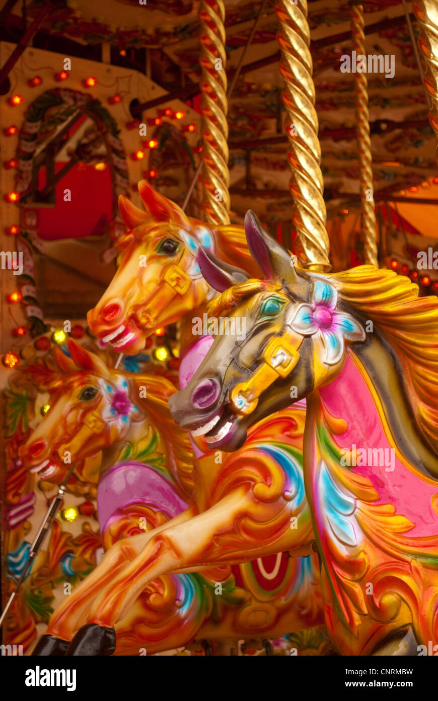 Three brightly colored carousel horses Stock Photo Alamy