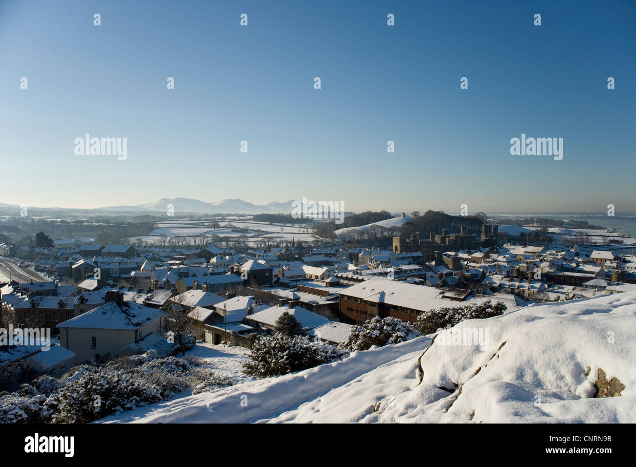Caernarfon castle and town from Twthill in the snow, Gwynedd,North