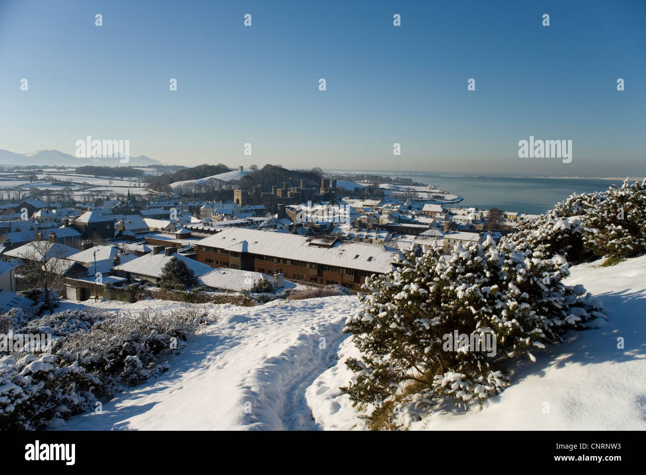 Caernarfon castle and town from Twthill in the snow, Gwynedd,North