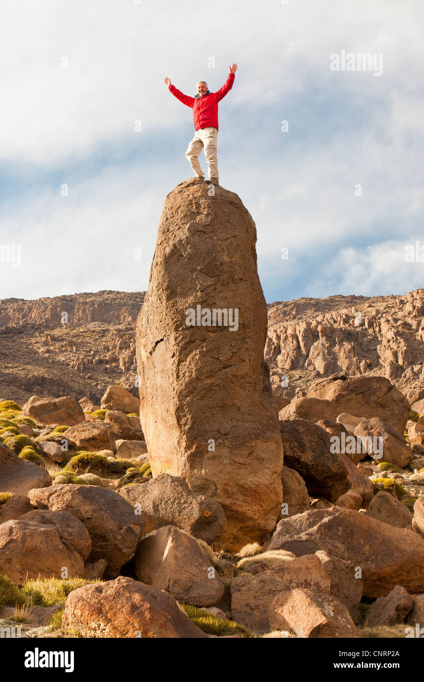 A climber on an exposed pinnacle in the Jebel Sirwa region of the Anti Atlas mountains of Morocco, North Africa. Stock Photo