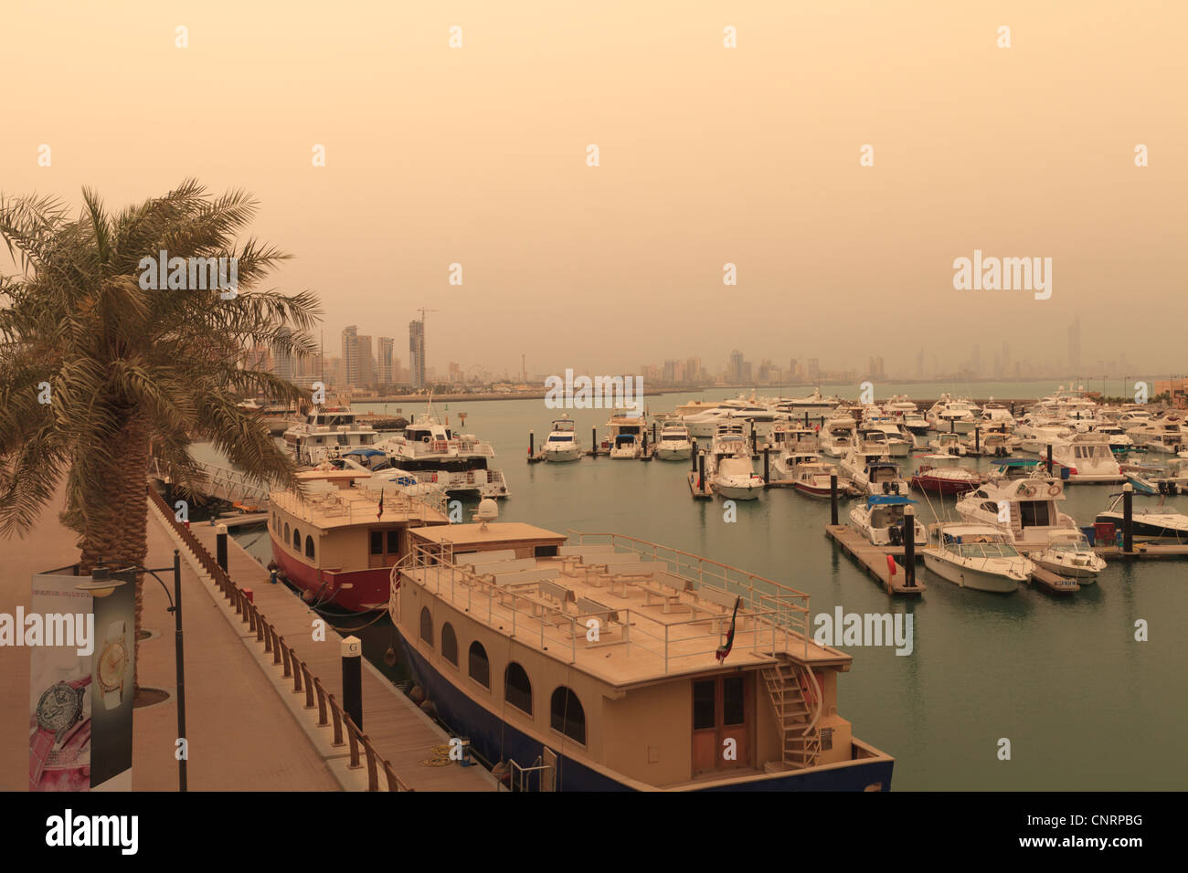 Hazy view across the marina after a recent sand storm from Marina Mall and Marina Crescent in Kuwait City Stock Photo