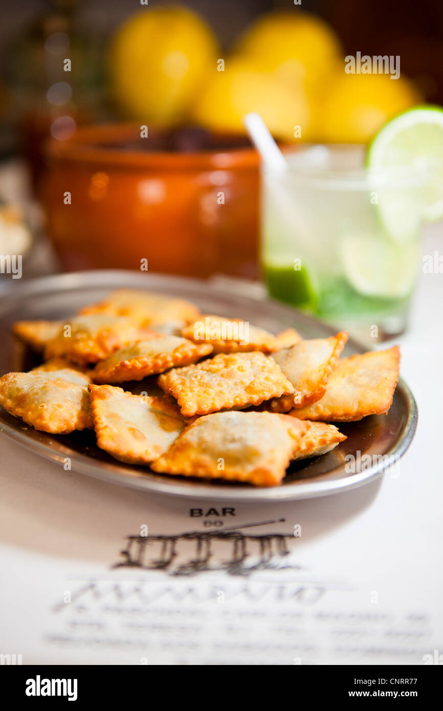 Bean pies ( pastel de feijao ) feijoada and caipirinha served at Bar do Mineiro, Santa Teresa quarter, Rio de Janeiro, Brazil. Stock Photo