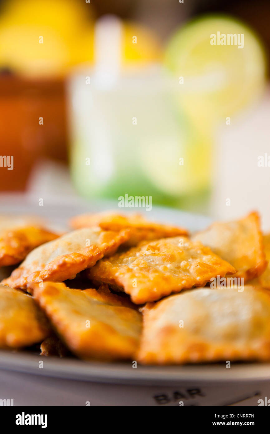 Bean pies ( pastel de feijao ) and caipirinha served at Bar do Mineiro, Santa Teresa quarter, Rio de Janeiro, Brazil. Stock Photo