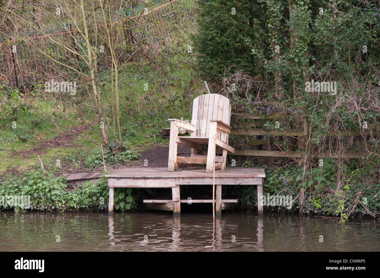 A crude easy chair commands a landing on the Staffordshire and Worcestershire Canal in the English Midlands Stock Photo