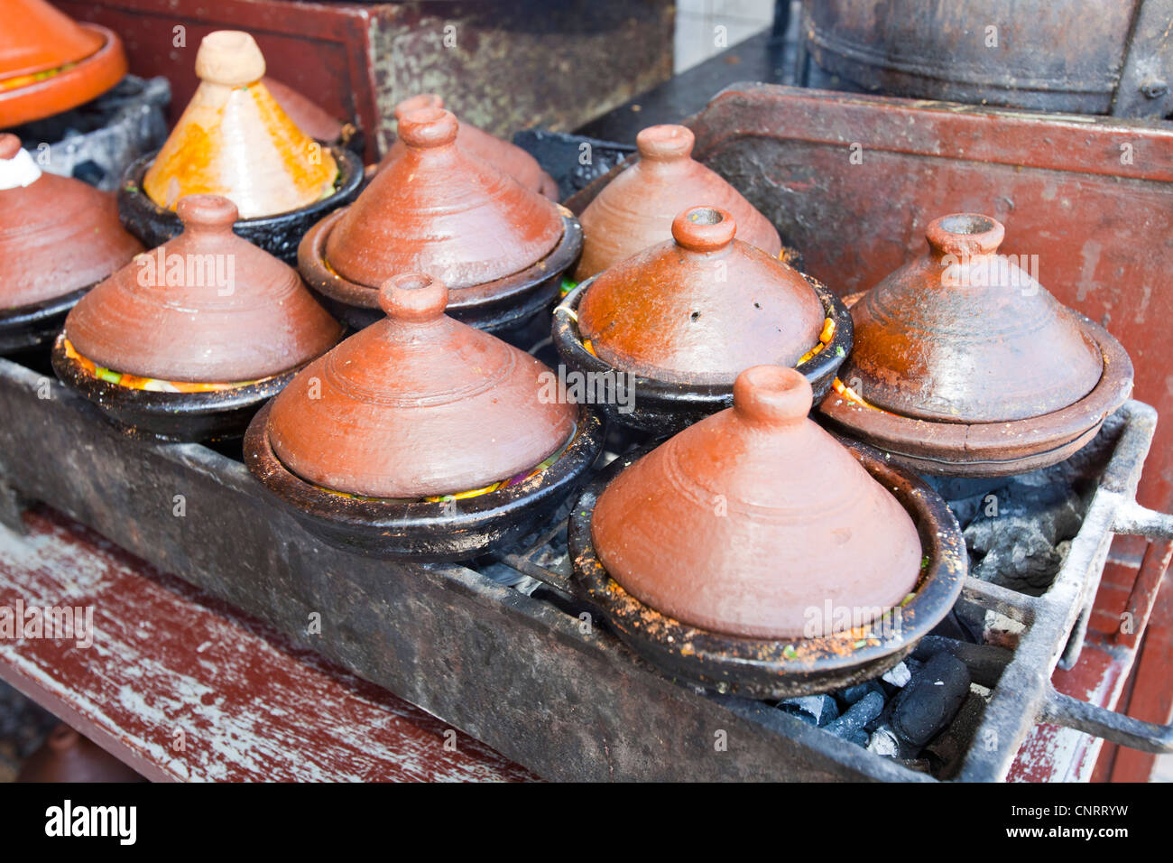 Tagines cooking on a cafe stove in Marrakech, Morocco, North Africa. Stock Photo