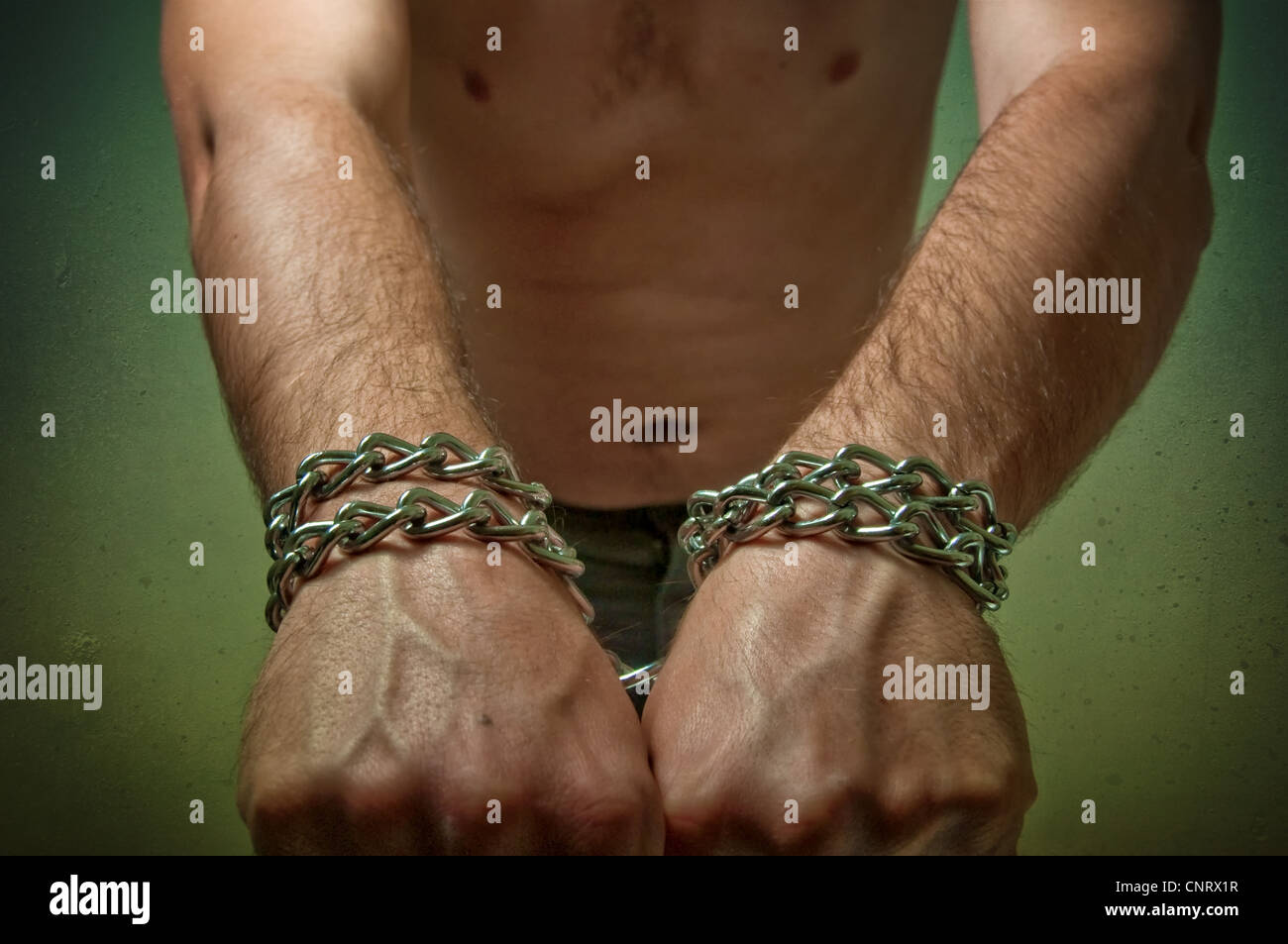 Male hands with chain wrapped around them, prisoner concept Stock Photo