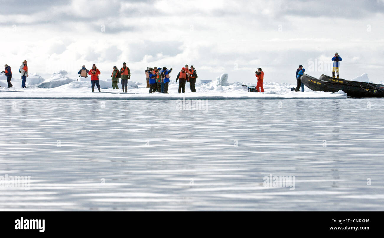 eco-tourists landing on pack ice at almost 80-degrees north during an Arctic expedition with the vessle Polar Star in June 2008, Norway, Svalbard Stock Photo