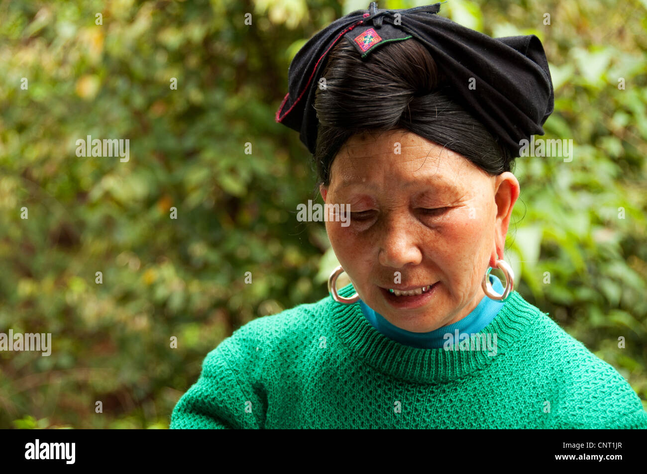 Portrait of an adult Yao woman with traditional hairstyle, Da Zhai village, Guangxi, China Stock Photo