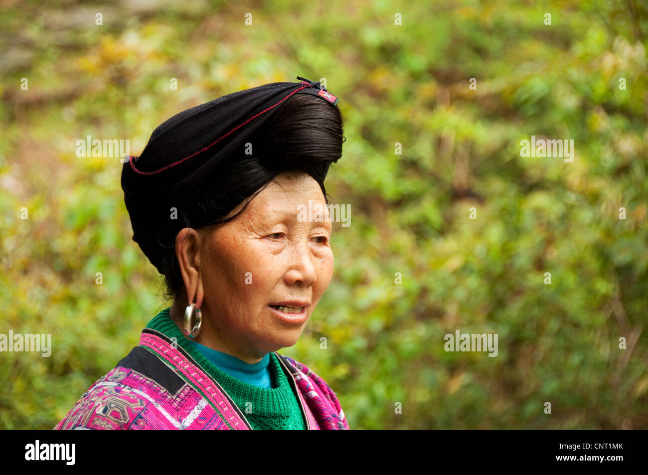 Portrait of an adult Yao woman with traditional hairstyle, Da Zhai village, Guangxi, China Stock Photo