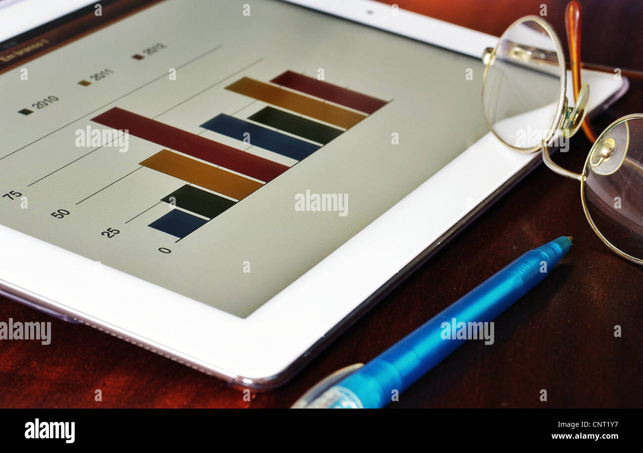 Bar chart in tablet with pen and glasses Stock Photo