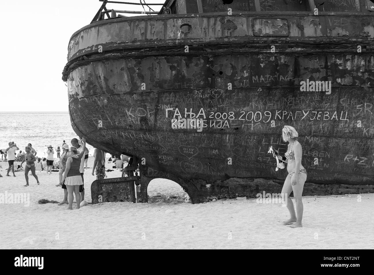 tourists at Navagio (shipwreck) Bay Stock Photo