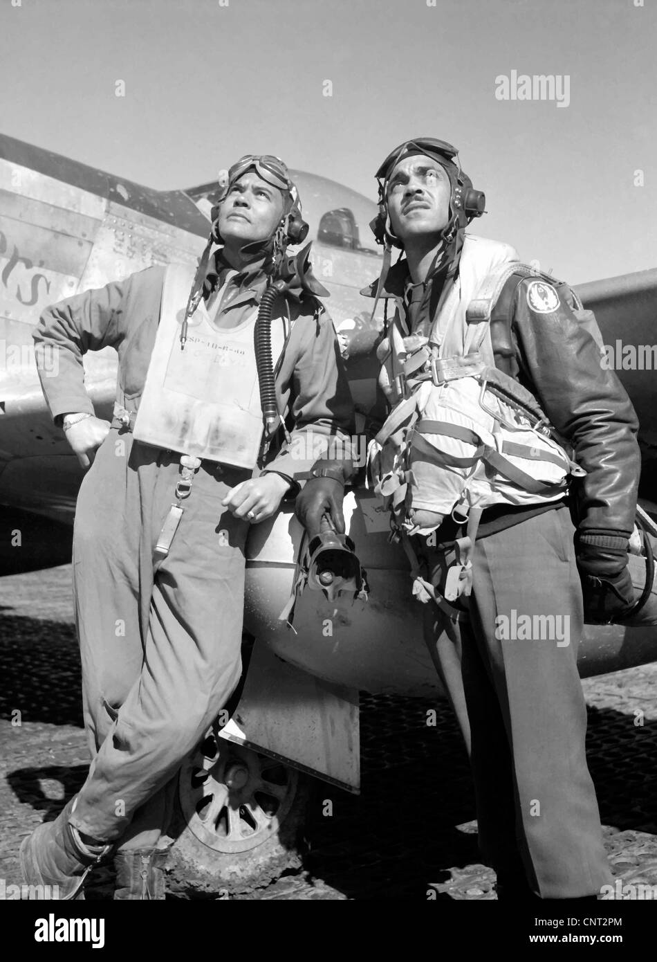 Members of the Tuskegee Airmen 332nd Fighter Group, posing with a P51D aircraft named Creamer's