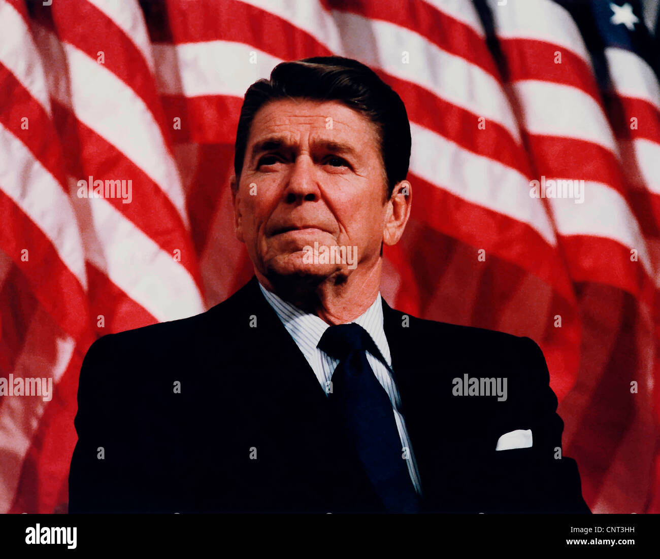 Digitally restored vector photo of President Ronald Reagan speaking in front of American Flags. Stock Photo