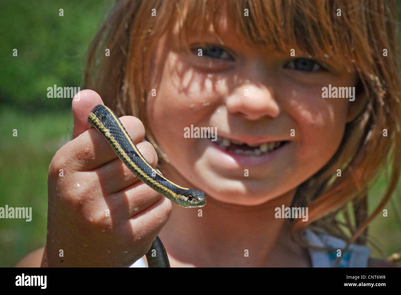 young girl garter snake smile happy wildlife reptile animal youth female Stock Photo