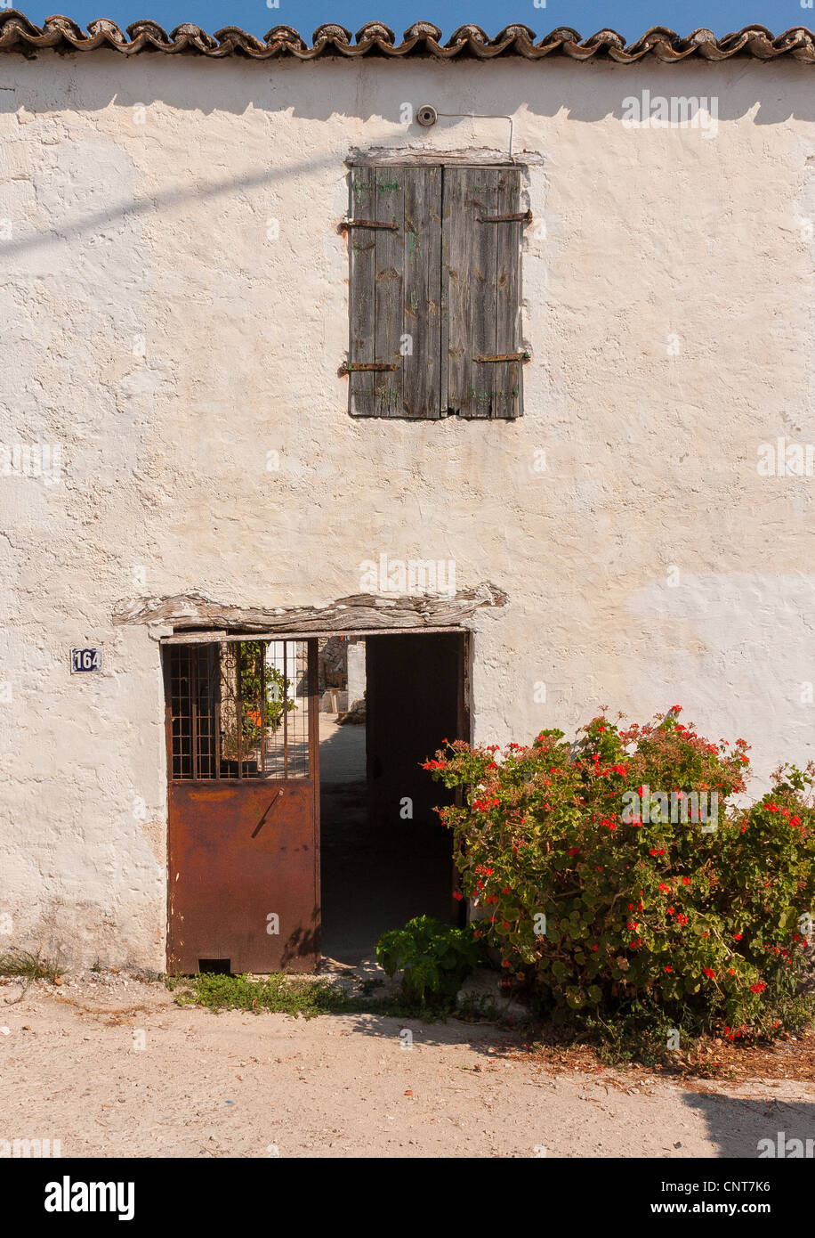 Door and shuttered window on a house in Agios Leon, Zakynthos, Greece Stock Photo
