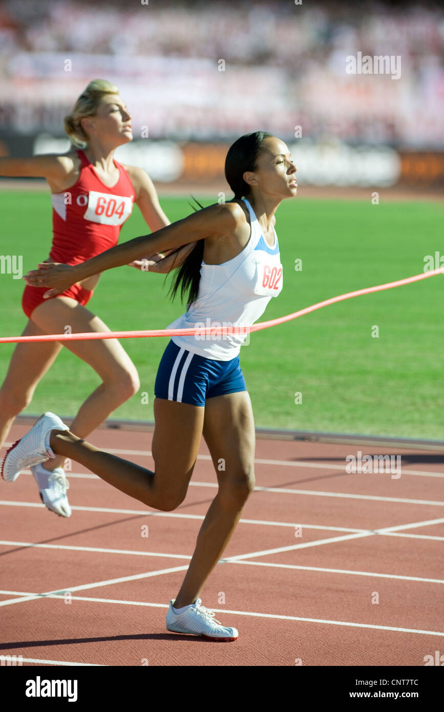 Woman Runner Crossing Finish Line Stock Photo by ©TijanaM 179079092