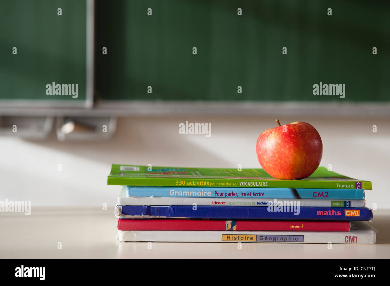 Apple on top of stacked books Stock Photo