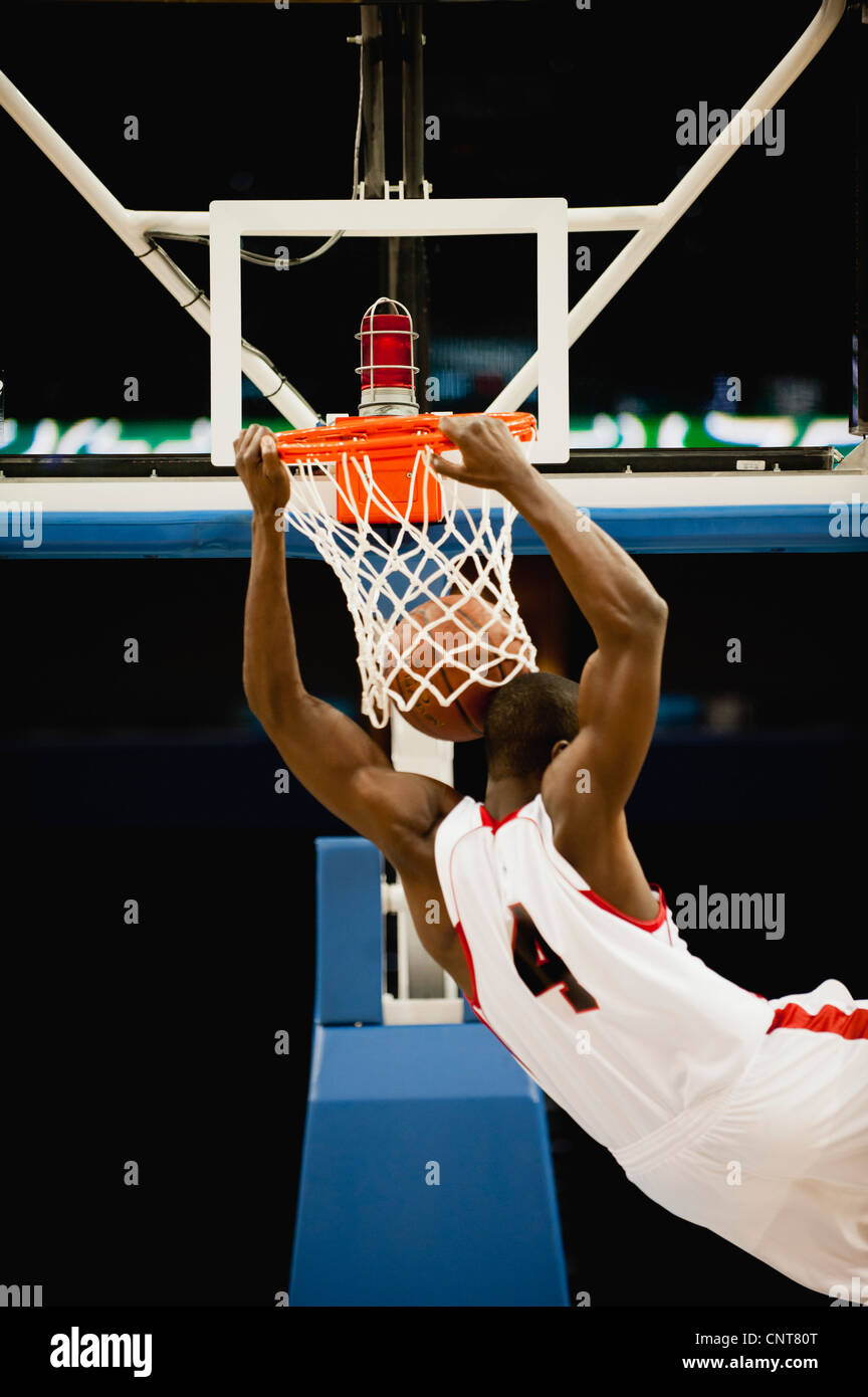 Basketball slam dunking, rear view Stock Photo