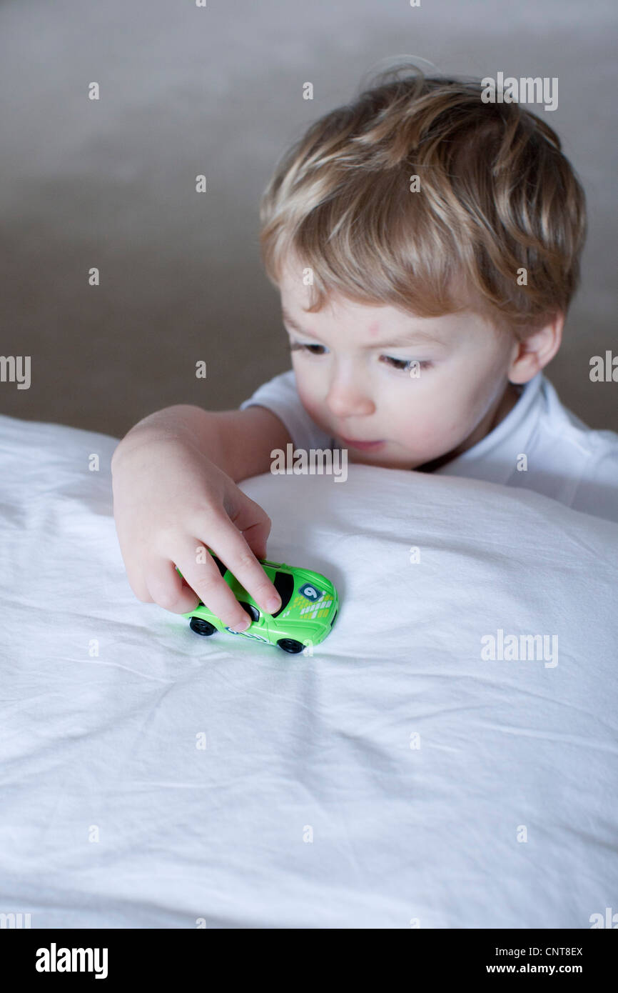 Little boy playing with toy car Stock Photo - Alamy
