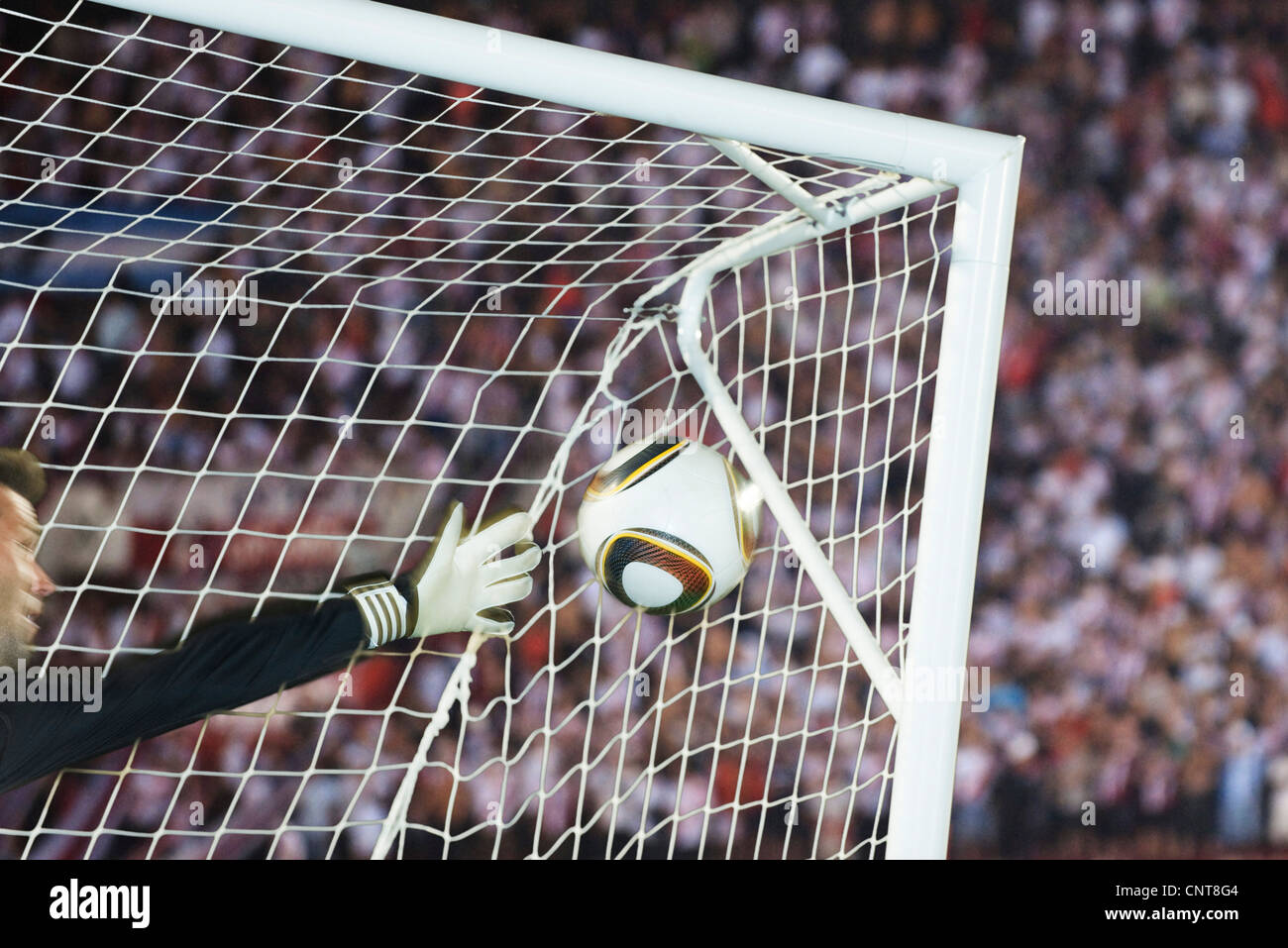 Soccer goalkeeper diving to block ball Stock Photo