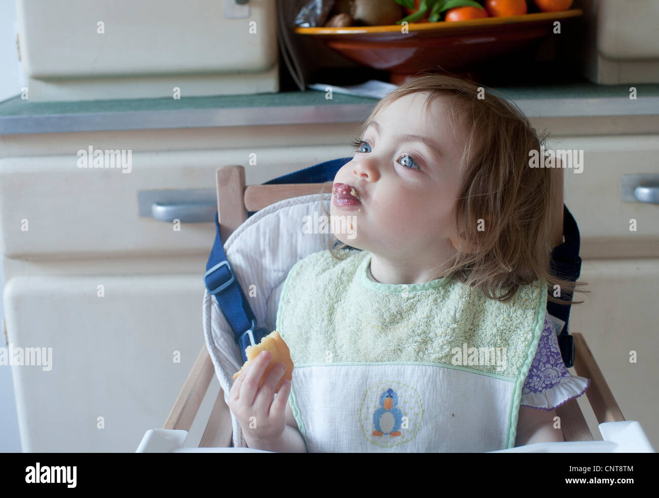 Toddler girl sticking her tongue out while eating Stock Photo Alamy